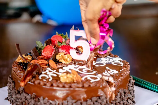 Close-up of a decorated chocolate cake for a 5th birthday celebration. Actors with February birthdays without the filler