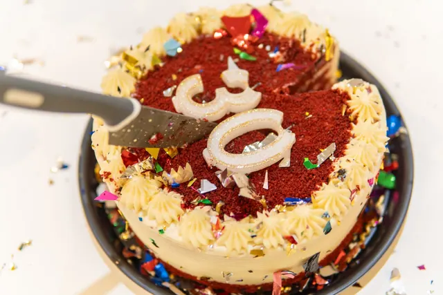 Vibrant red velvet cake with cream frosting and colorful candles, perfect for a birthday celebration. Celebrity birthdays in December 2027: a dated guide for holiday planning