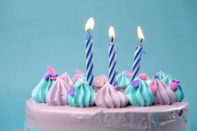 A vibrant birthday cake with pastel icing and lit candles, perfect for celebrations. Celebrity birthdays on federal holidays follow a calendar of conflicts