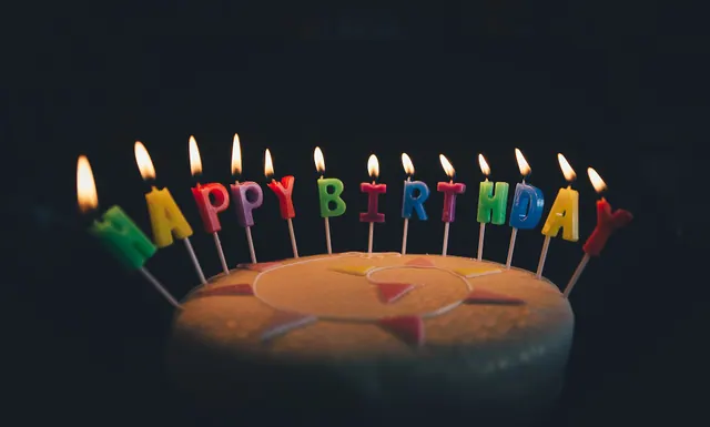 Birthday Cake with Candles (Unsplash M20ylqCzSZw). How to verify a celebrity's birth date when two sources disagree