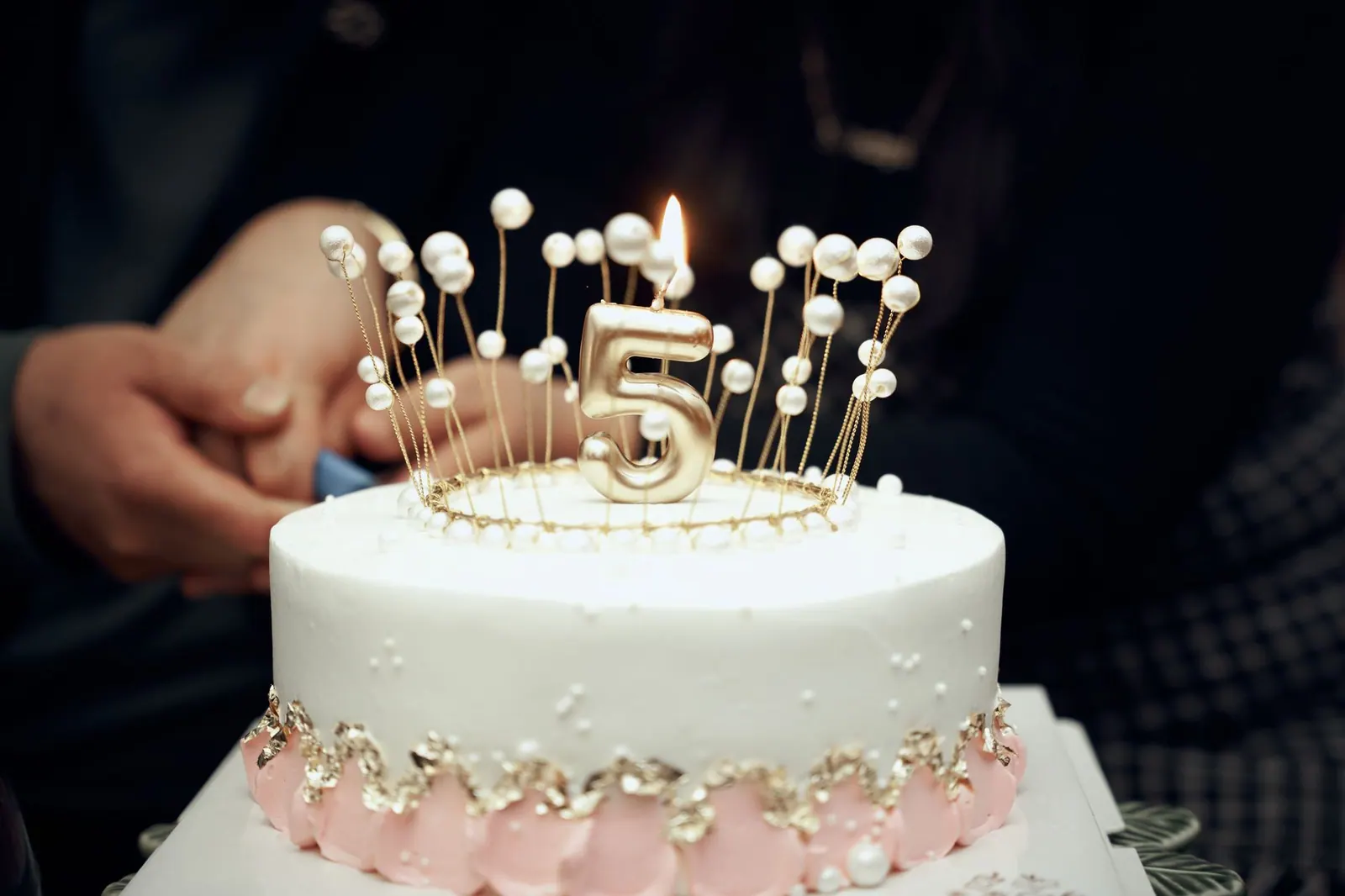 A beautifully decorated cake with a golden number five candle lit on top, perfect for a fifth birthday celebration. Members of Congress with February birthdays: a state-by-state calendar